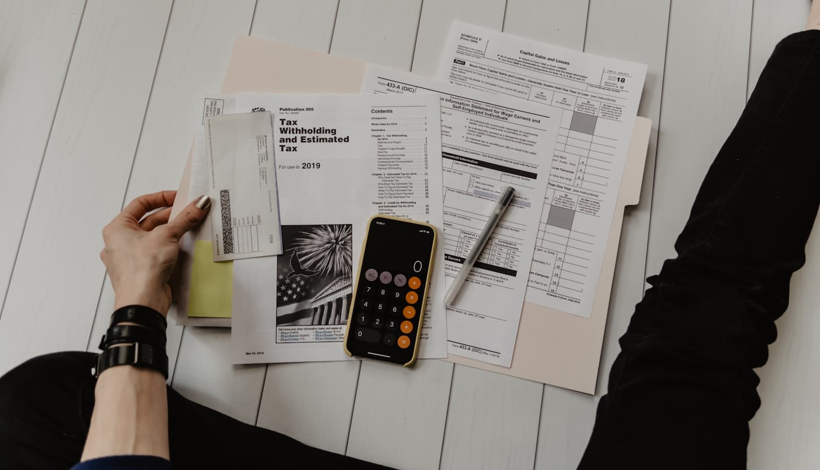 Business owner reviewing financial documents at a modern office desk
